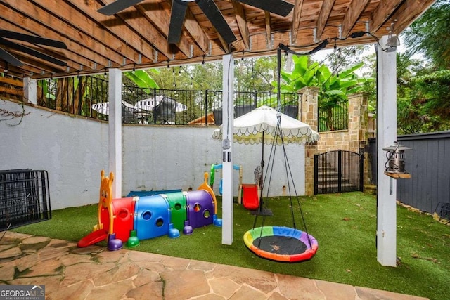 view of playground with ceiling fan and a patio area