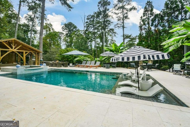 view of pool with a gazebo, a patio, and an in ground hot tub