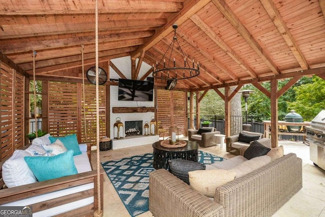 view of patio / terrace with an outdoor living space with a fireplace