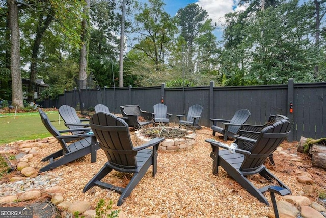 1409 Sheridan Rd NE, Atlanta, GA 30324 - view of yard with an outdoor fire pit, view of wooded area, and an area to practice putting