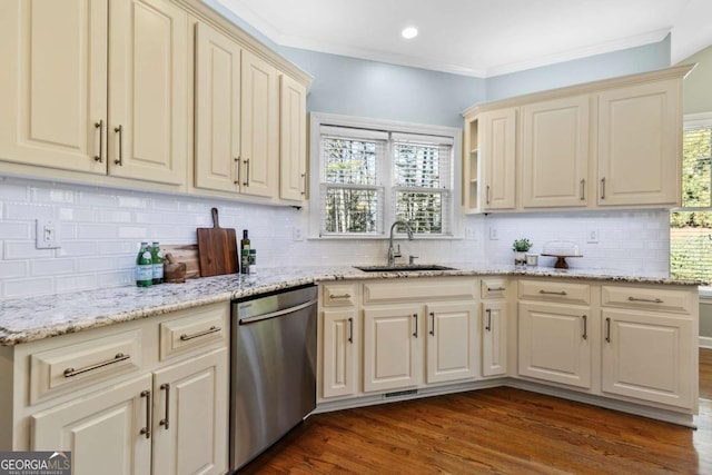 kitchen featuring cream cabinetry, dishwasher, wood-type flooring, and sink