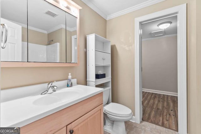 bathroom with vanity, toilet, a shower, and crown molding