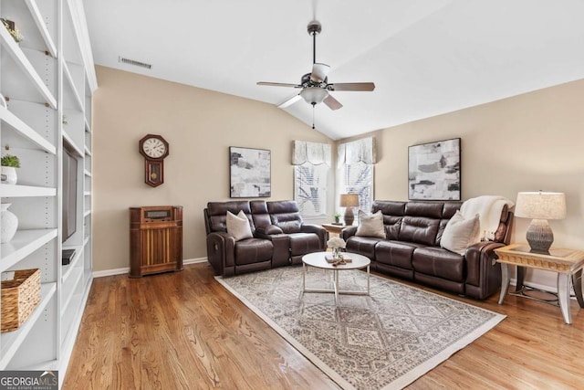 living room featuring ceiling fan, light hardwood / wood-style flooring, and lofted ceiling