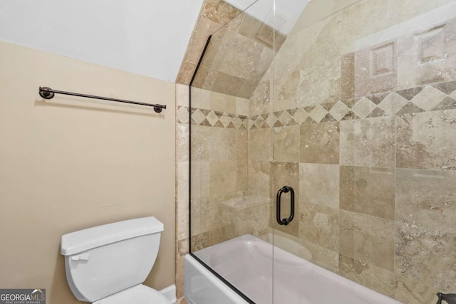 bathroom featuring bath / shower combo with glass door and toilet