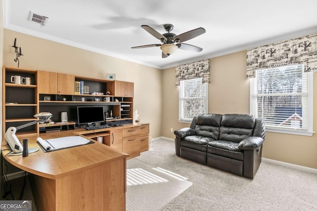 home office with ceiling fan, crown molding, and light carpet