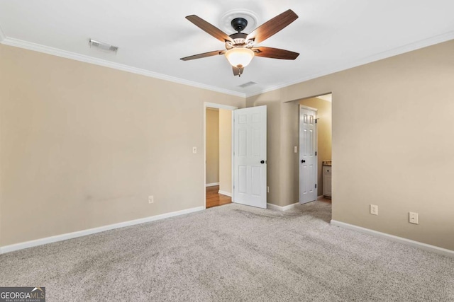 unfurnished room featuring crown molding, ceiling fan, and light colored carpet