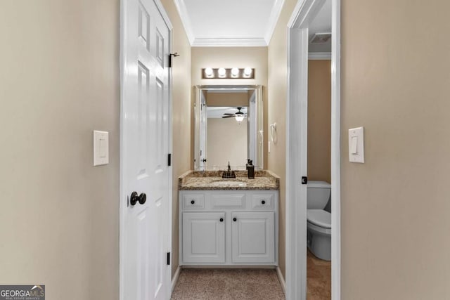 bathroom featuring vanity, ceiling fan, toilet, and ornamental molding