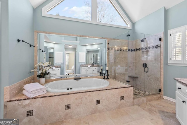 bathroom featuring plenty of natural light, vanity, independent shower and bath, and vaulted ceiling