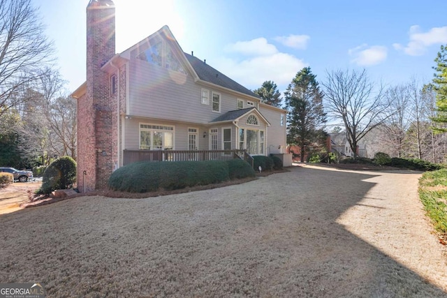 view of side of property featuring a wooden deck