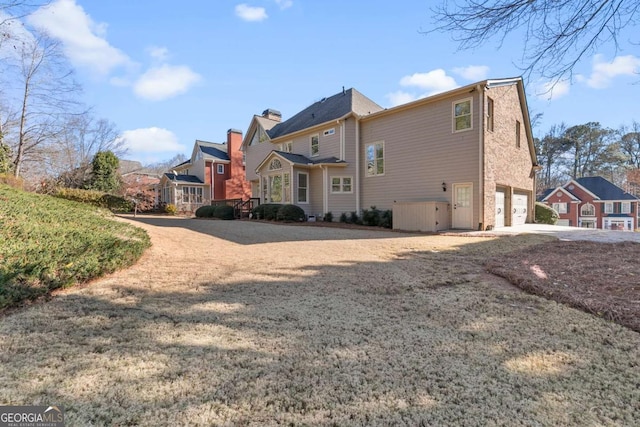 back of house featuring a garage