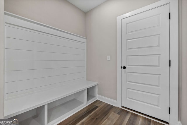 mudroom featuring dark wood-type flooring and baseboards