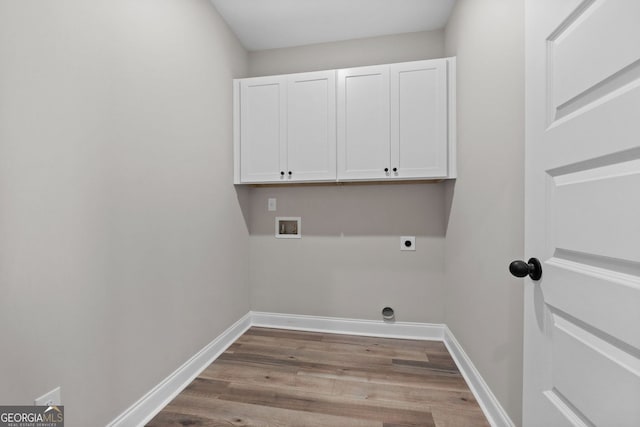 washroom featuring baseboards, hookup for a washing machine, cabinet space, and hookup for an electric dryer