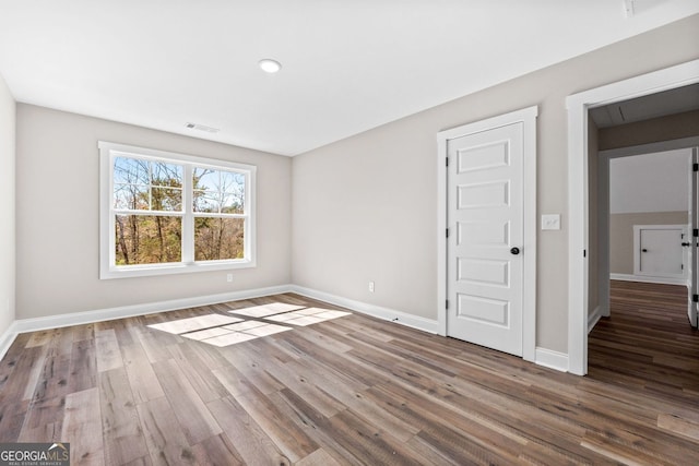 interior space featuring visible vents, baseboards, and wood finished floors