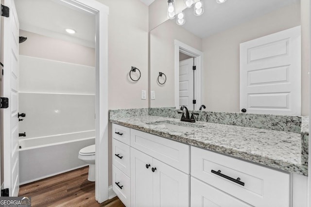 full bath with vanity, toilet, and wood finished floors