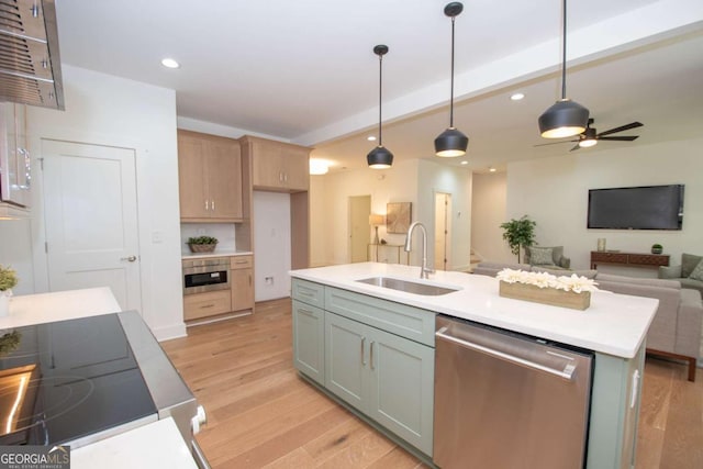 kitchen with dishwasher, sink, hanging light fixtures, an island with sink, and light hardwood / wood-style floors