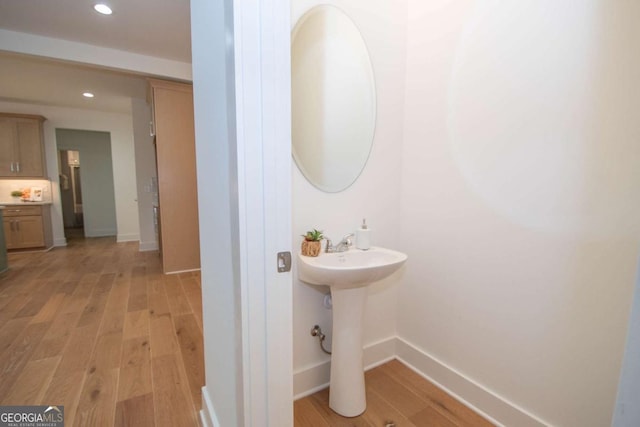 bathroom with hardwood / wood-style flooring and sink