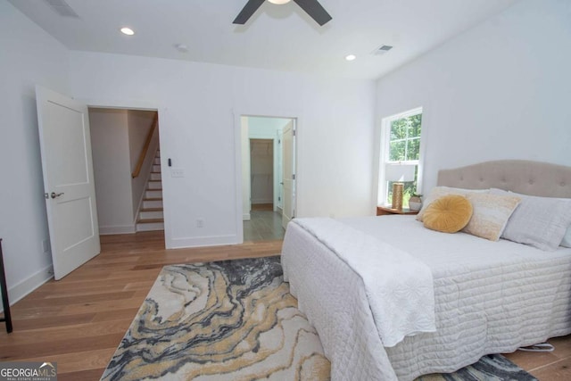 bedroom with wood-type flooring and ceiling fan