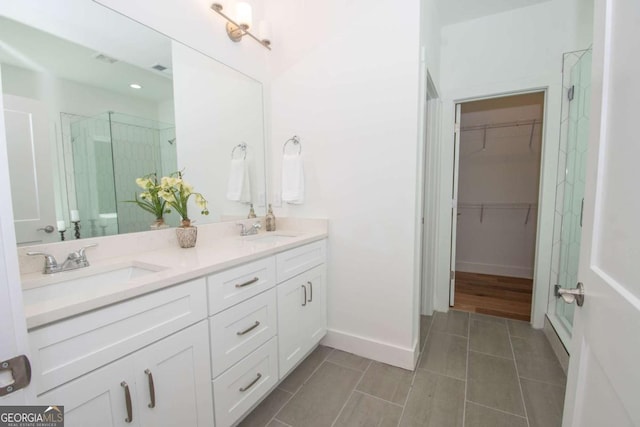 bathroom with tile patterned floors, vanity, and an enclosed shower