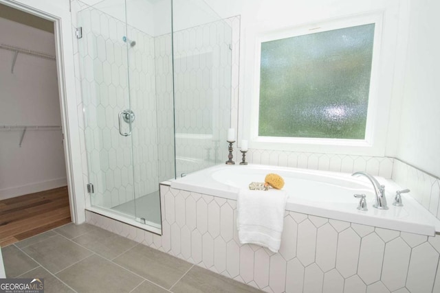 bathroom with tile patterned flooring and independent shower and bath