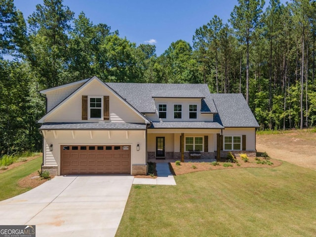 view of front of house with a porch, a garage, and a front yard