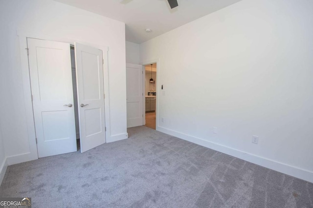 unfurnished bedroom with ceiling fan and carpet floors