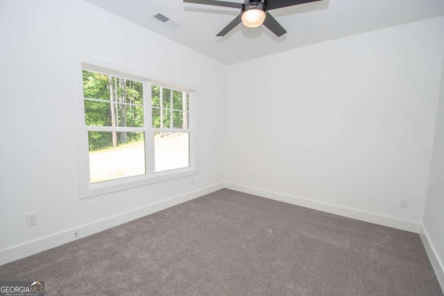 carpeted spare room featuring ceiling fan