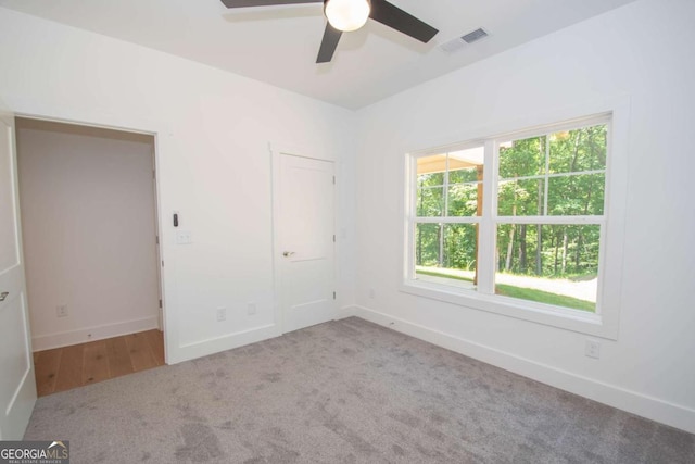 unfurnished bedroom featuring ceiling fan and carpet