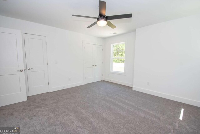 unfurnished room with carpet and ceiling fan