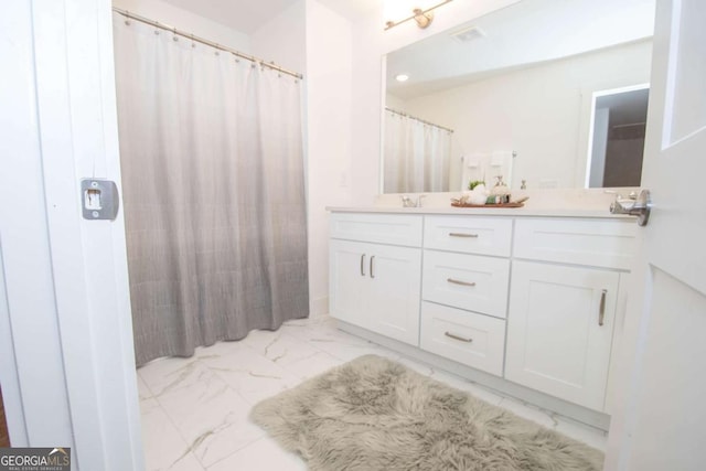 bathroom featuring vanity and a shower with shower curtain