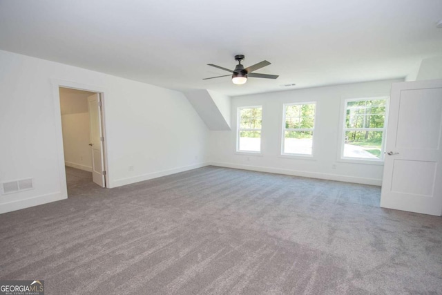 additional living space with ceiling fan and carpet floors