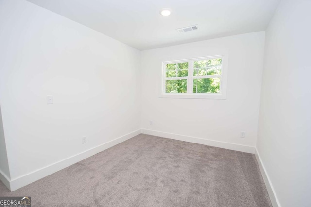 empty room featuring light carpet