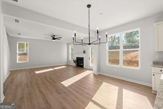 unfurnished living room with ceiling fan and light hardwood / wood-style flooring