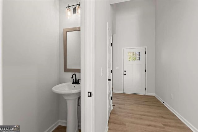 bathroom with hardwood / wood-style floors and sink