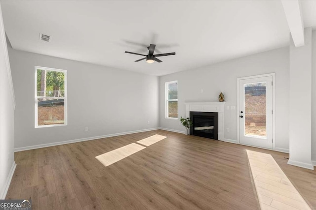 unfurnished living room featuring ceiling fan and light hardwood / wood-style floors