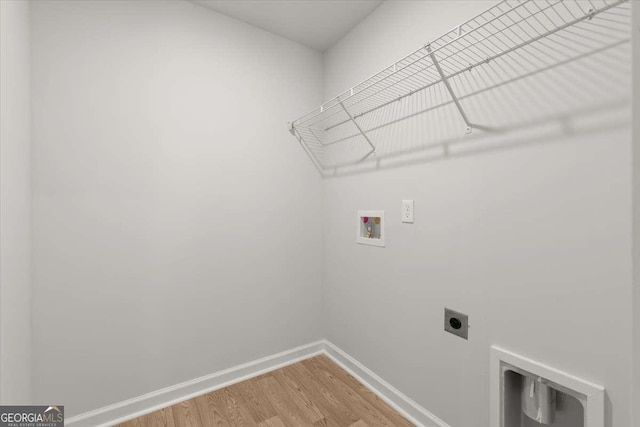 laundry area with hookup for an electric dryer, hardwood / wood-style flooring, and washer hookup