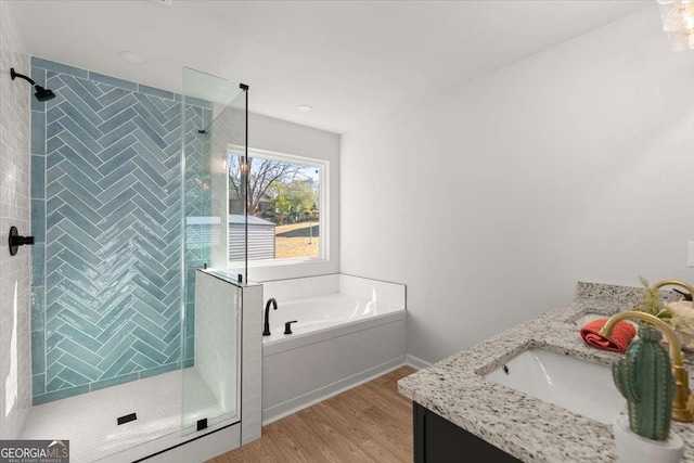 bathroom with vanity, wood-type flooring, and shower with separate bathtub