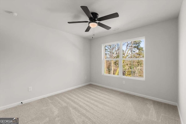 empty room featuring carpet flooring and ceiling fan