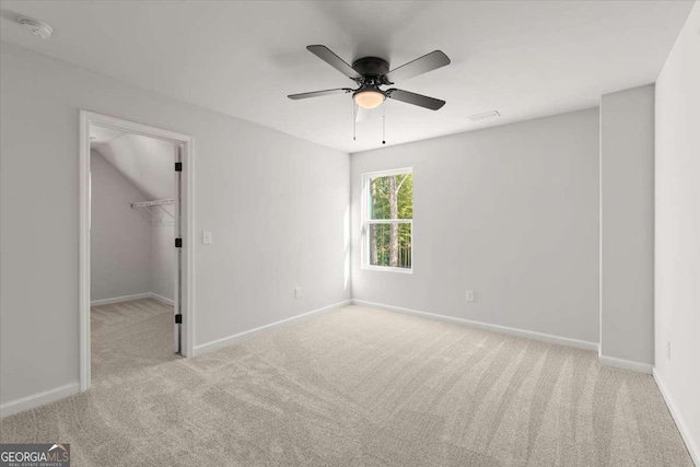 empty room featuring light carpet and ceiling fan