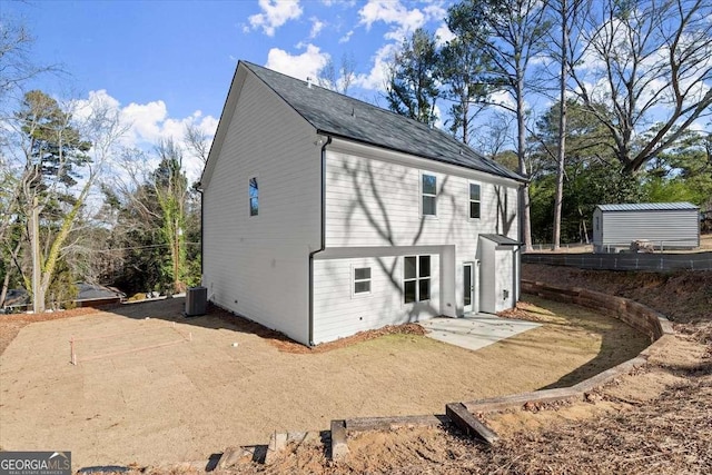 rear view of property featuring central AC and a patio