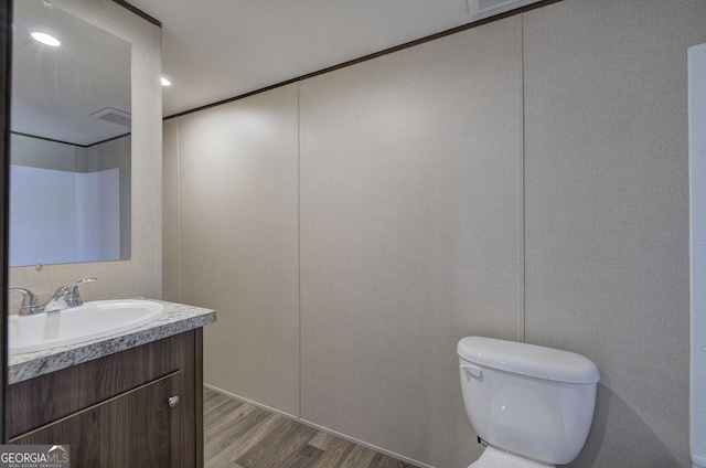 bathroom featuring hardwood / wood-style floors, vanity, and toilet