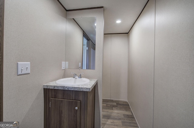 bathroom with hardwood / wood-style floors and vanity