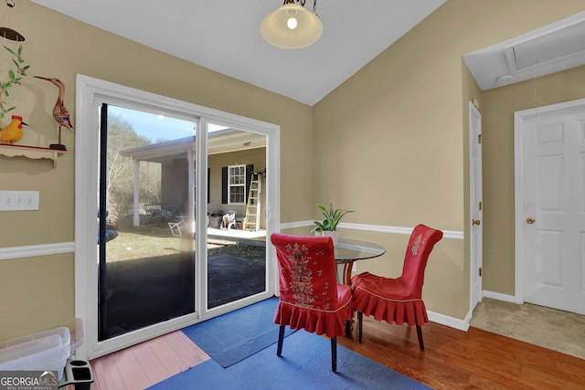 dining room with vaulted ceiling and hardwood / wood-style flooring