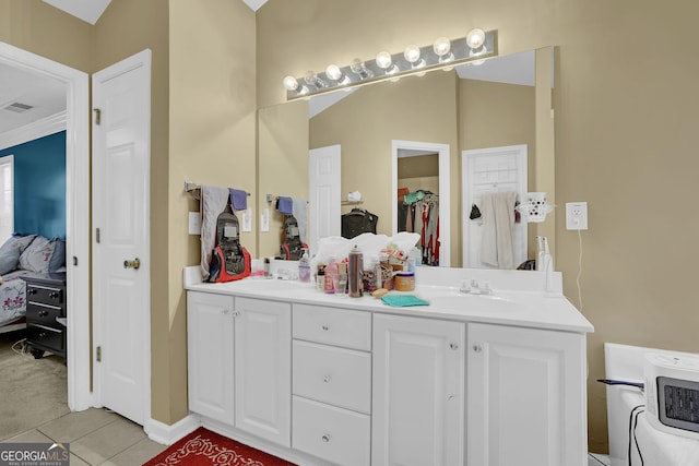 bathroom with tile patterned flooring, vanity, and crown molding