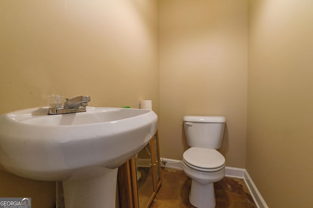 bathroom with toilet and sink