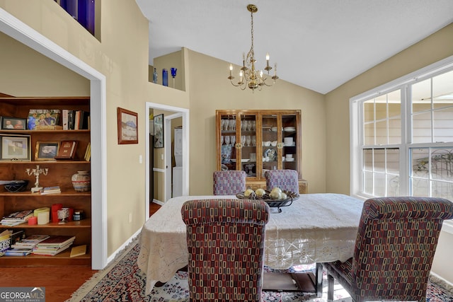 dining room featuring vaulted ceiling and a chandelier