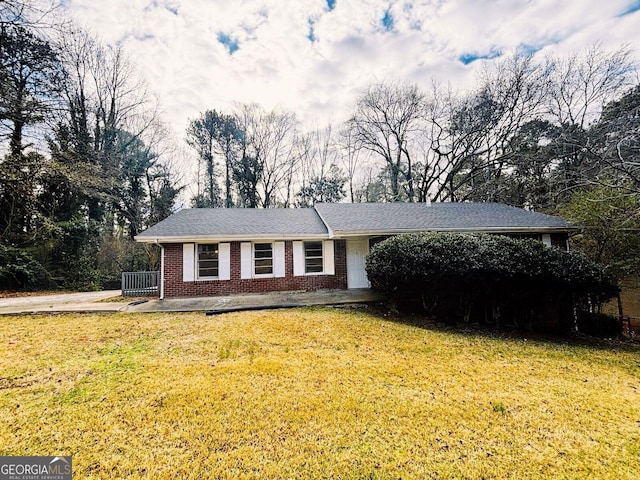 ranch-style house with a front lawn