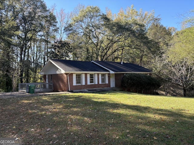 ranch-style home with a front lawn