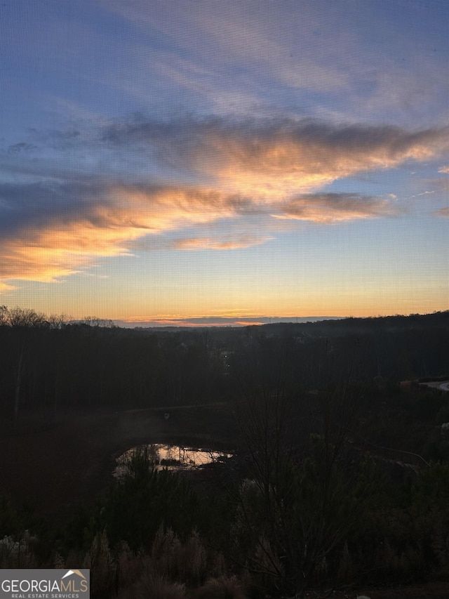 nature at dusk featuring a water view