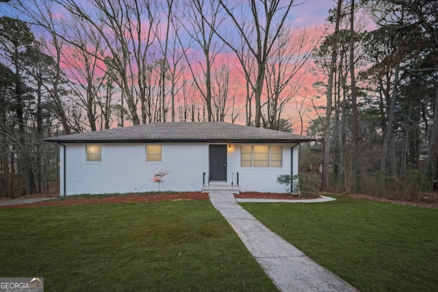 single story home with brick siding and a front lawn