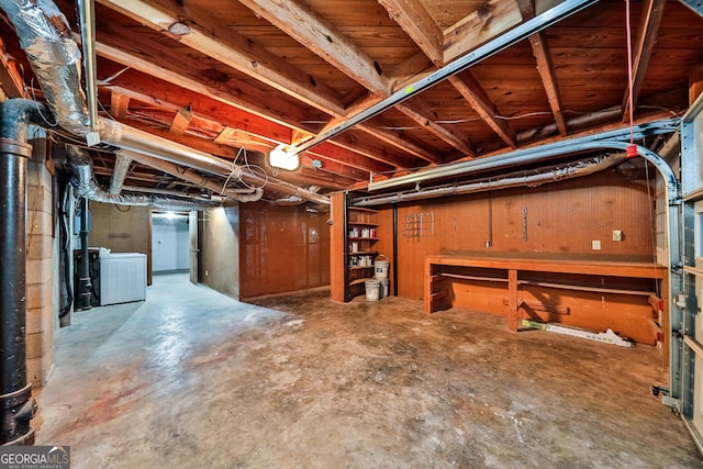 basement featuring washer and dryer and a workshop area